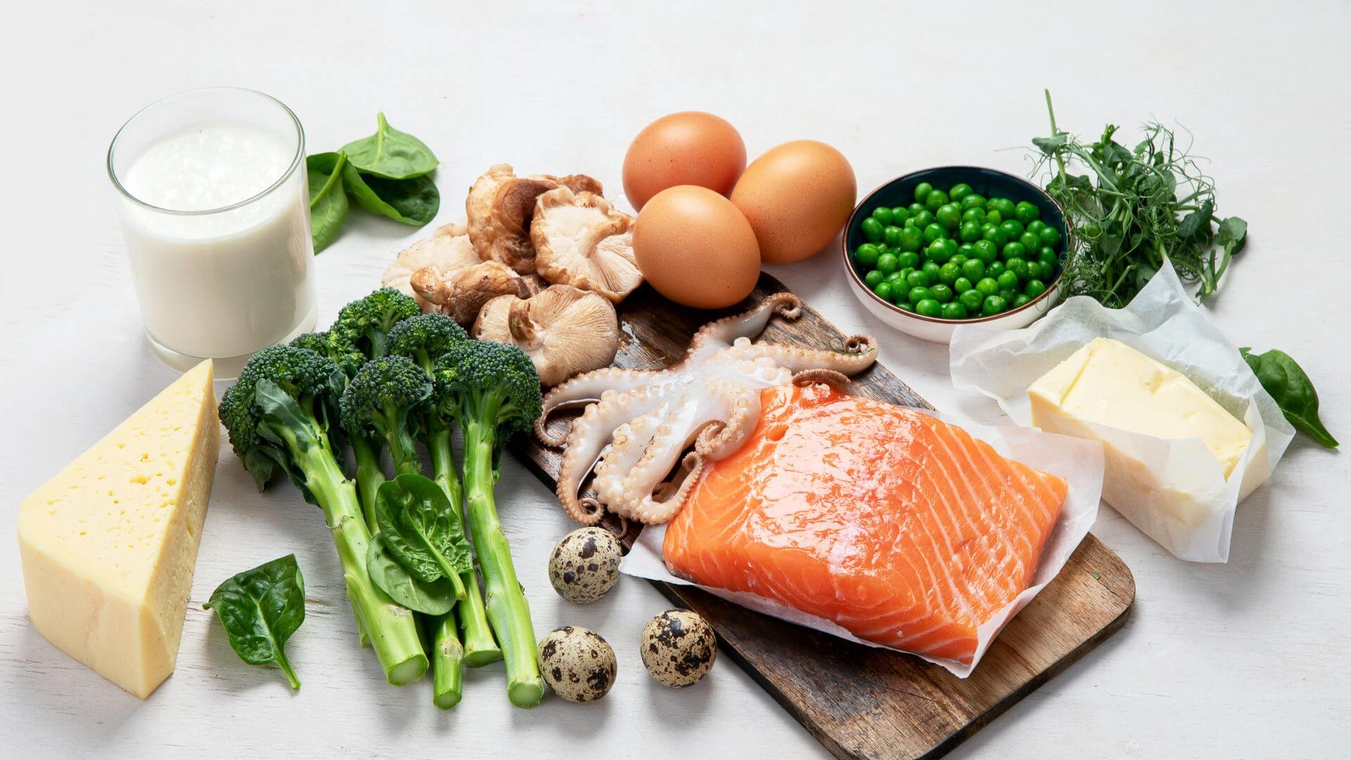 Composition with products rich in vitamin D on white background, top view.